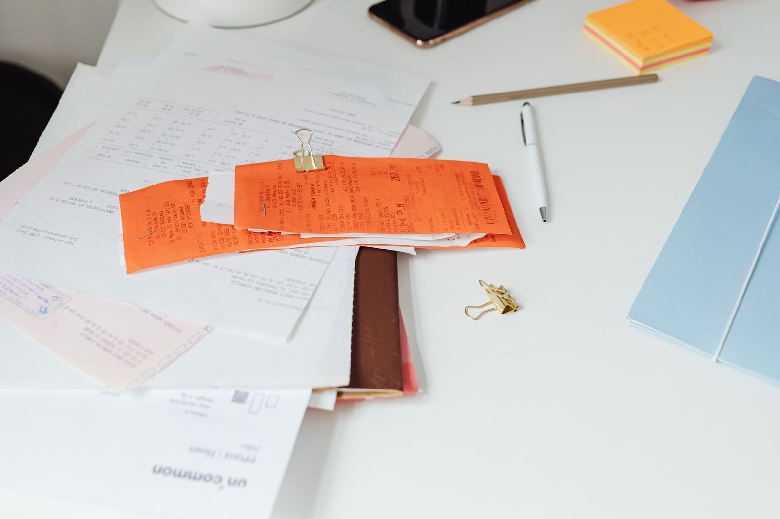 Desk with receipts, documents and stationery