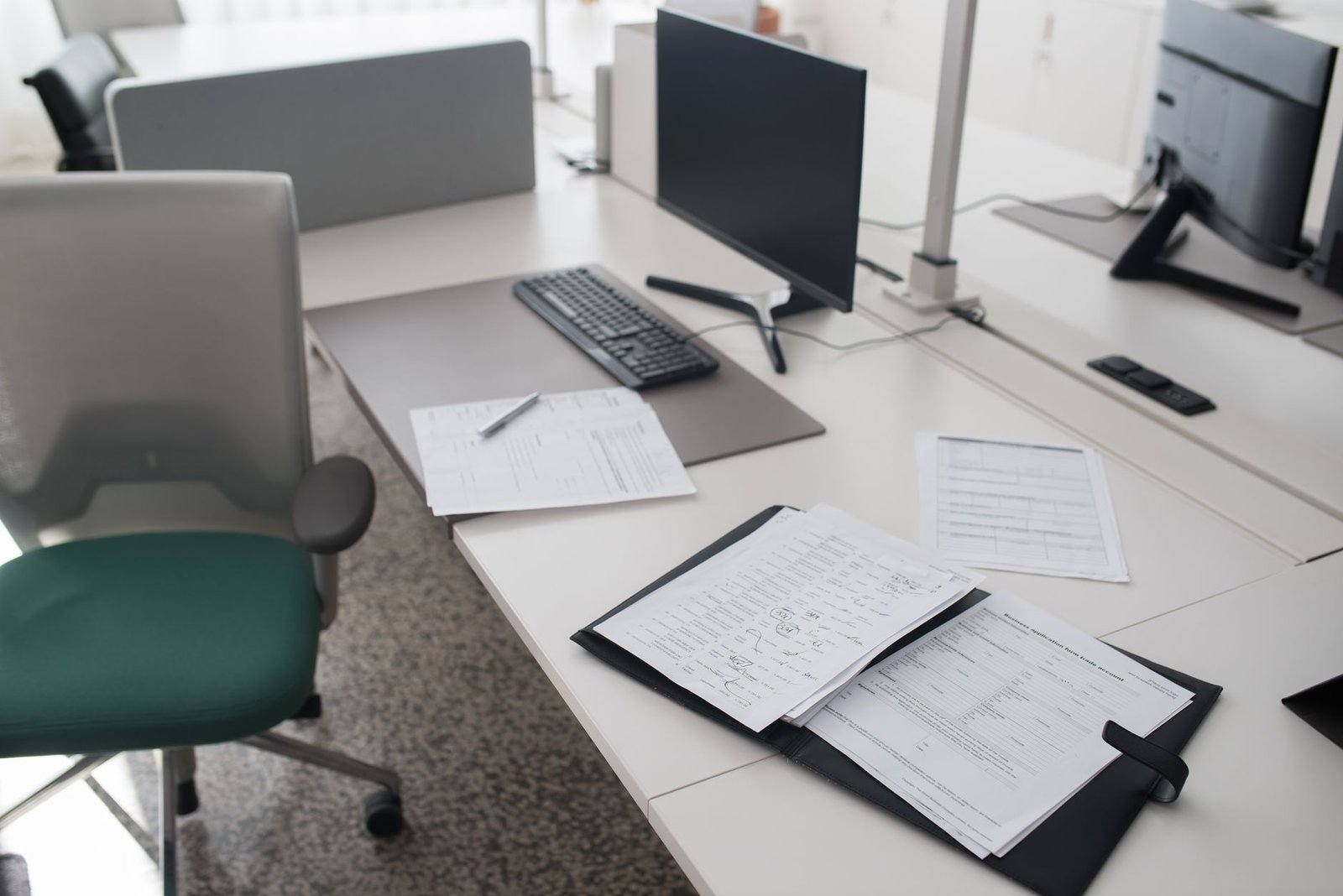 Tidy desk with documents and a computer